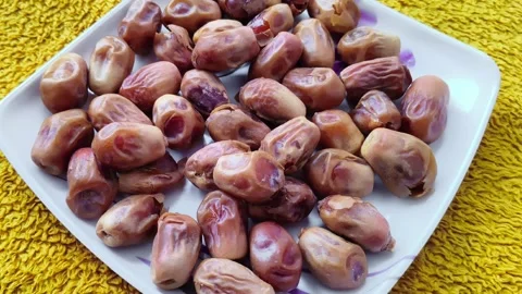 Close up of fresh brown dates served on a white square plate Видео 328156446