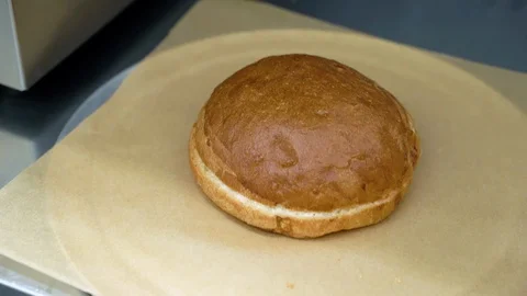 Close - up of fresh burger bun served on pieces of brown paper Stock Footage 115840902