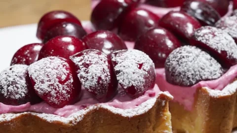 Close-up of Fresh Cherry Tart with Pink Custard Filling and Powdered Sugar Duste Stock Footage 337751319