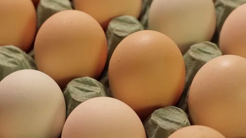 Close up of fresh chicken eggs in a recycled cardboard carton on a rotating.. Stock Footage 337543002
