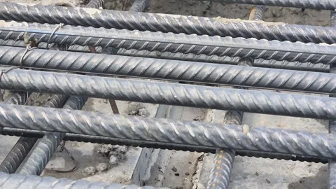 Close up of fresh concrete flowing underneath rebar matrix Stock Footage 343285238