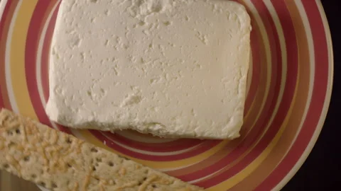 Close-up of fresh cottage cheese on a red platter indoors. 스톡 동영상 135224682