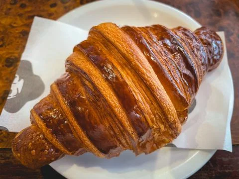 Close up from a fresh croisant in a restaurant. Stock Photos