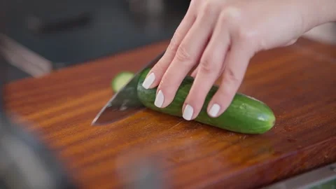 Close Up of Fresh Cucumber Being Sliced on Wooden Board Stock Footage 336466905