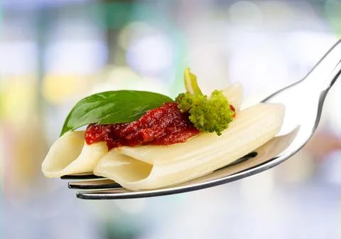 Close-up of fresh delicious pasta on fork on background Stock Photos