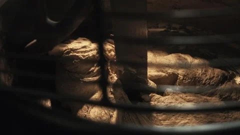 Close up fresh dough mixing process inside large spiral industrial mixer machine Stock Footage 340385970