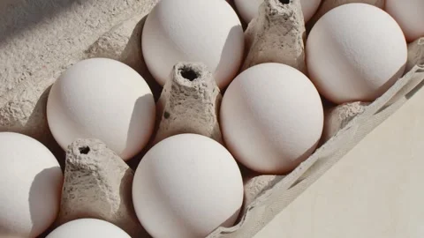 Close-up of fresh eggs in packaging on a light background, promoting the qu.. Stock Footage 261098116