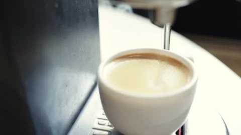 Close-up of fresh espresso being brewed into a white cup by a machine Stock Footage 339000462