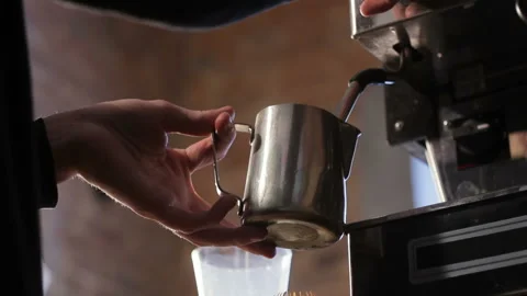 Close-up fresh espresso pours in metal cup, Italian espresso machine Video stock 105159953