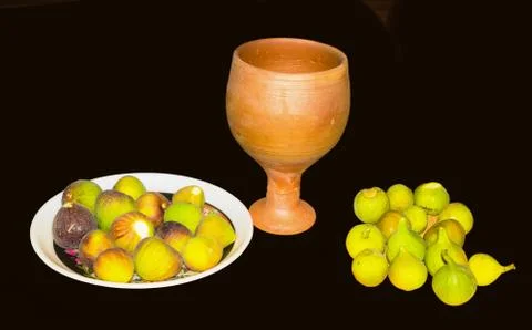 Close up of fresh fig fruit in a plate with clay glass isolated Stock Photos