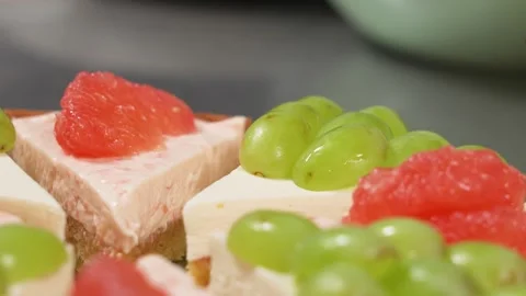 Close-up of Fresh Fruit Cheesecake with Grapes and Grapefruit Stock Footage 337751263