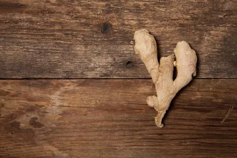 Close up of fresh ginger root spice on wooden table Stock Photos