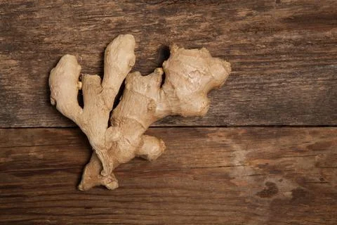 Close up of fresh ginger root spice on wooden table Stock Photos