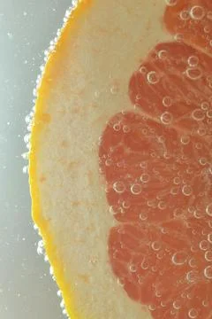Close-up of fresh grapefruit slice on white background. Slice of red grapef.. 스톡 사진