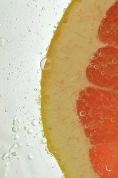 Close-up of fresh grapefruit slice on white background. Slice of red grapef.. Stock-Fotos