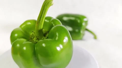 Close-up of fresh green bell pepper on a white background. Stock Footage 340938128