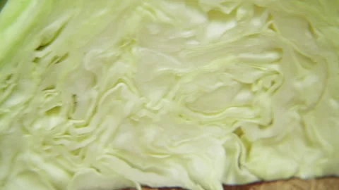 Close up of fresh green cabbage cut in half showing layered leafy texture Stock Footage 340609222