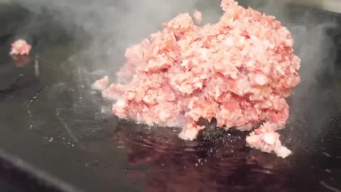 Close-Up of Fresh Ground Meat Sizzling on a Hot Griddle Stock-Footage 332814573