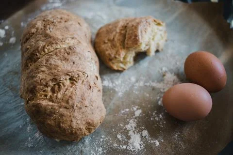 Close-up of a fresh homemade bread on baking paper  Stock Photos