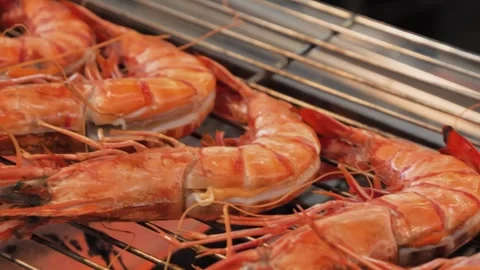 Close-Up of Fresh Jumbo Prawns Grilling on an Open Flame BBQ Grate Stock Footage 344220119