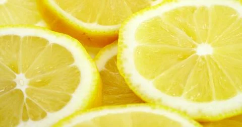 Close up fresh lemon slices pattern background. Bright juicy slice lemon Texture Stock Photos