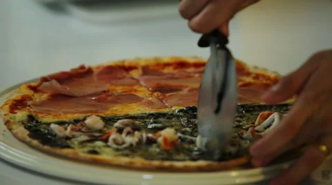 Close up of fresh made pizza cutting with roller. Stock Footage 51936492