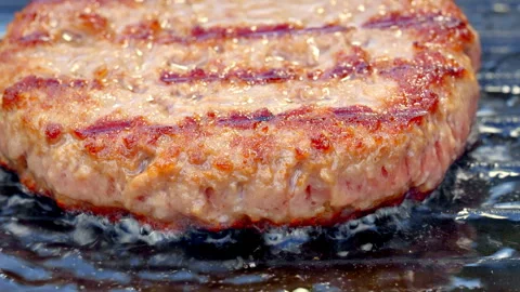 Close-up of fresh minced beef burger patty cooking on a pan. Street food. Stock Footage 315903160