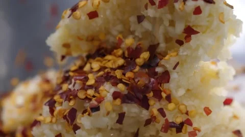 Close-up of Fresh Minced Garlic Topped with Spicy Red Chili Flakes Stock-Footage 332811174
