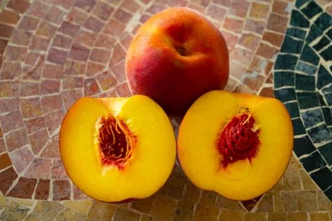 Close up of fresh nectarines on a stone table Stock Photos