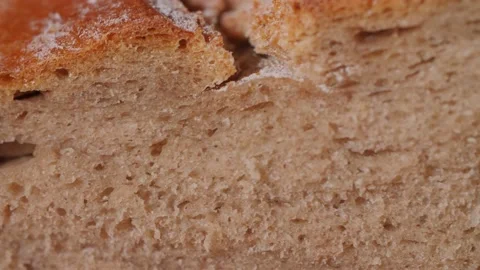 Close up of a fresh organic bread loaf being squeezed and the pores compressed. Stock Footage 145973644