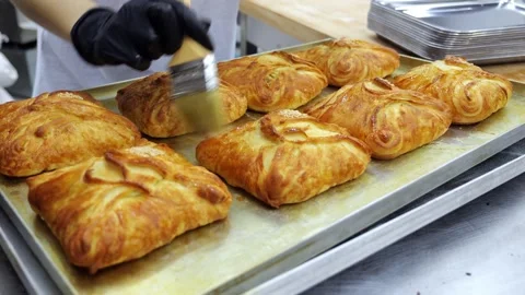 Close-up of fresh pastries on a shelf in a dining room or pastry shop. Stock Footage 341550843
