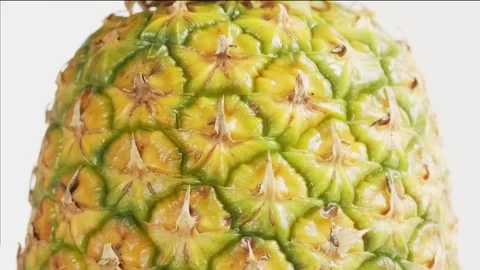 Close-up of a fresh pineapple as water splashes hit its surface. Dynamic an.. Stock Footage 314431252