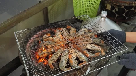 Close-Up of Fresh Prawns Grilling in a Circle over Charcoal Flame Stock Footage 344227610