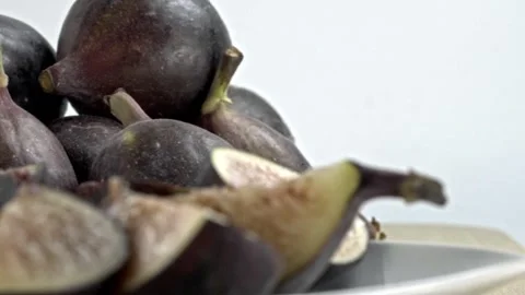 Close Up of Fresh Purple Figs and Cut Fig Pieces Showing Ripe Red Flesh and Stock Footage 345529229