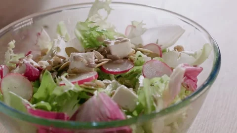 Close up fresh radishes cut in thin slices are add in cabbage salat with Video stock 151961561
