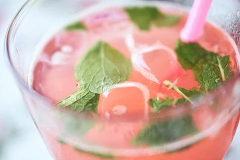 Close-up of fresh raspberry lemonade in a glass with ice cubes and mint leave Stock Photos