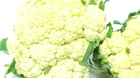 Close-up of fresh raw cauliflower head isolated on white background. Stock Footage 338990532