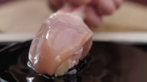 Close-up of fresh raw chicken legs dipped in dark teriyaki sauce Stock Footage 158815916