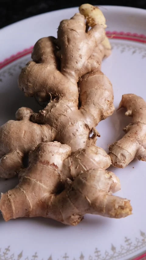 Close-up of Fresh Raw Ginger Roots on a Ceramic Plate Video stock 332101448