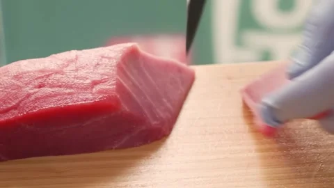 Close-up of Fresh Raw Tuna Saku Loin for Sashimi on Wooden Cutting Board Stock Footage 333600523