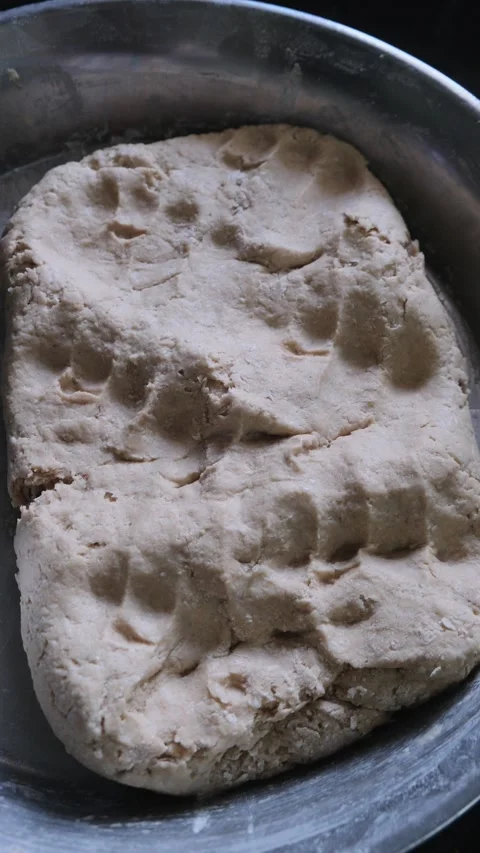 Close up of fresh raw wheat dough in a steel bowl for making bread Stock Footage 331987367
