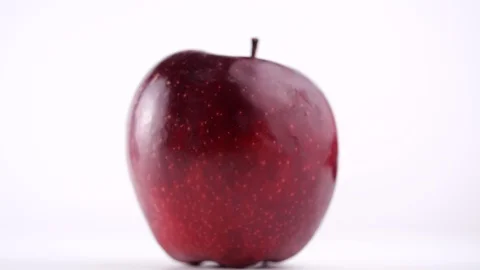 Close-up of fresh red apple rotating on white background in 4K resolution 스톡 동영상 129069017