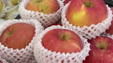 Close up of fresh red apples stacked on a display at a grocery store. Stock Footage 325449944