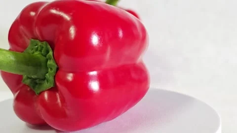Close-up of fresh red bell pepper with green stem. Stock Footage 340937781