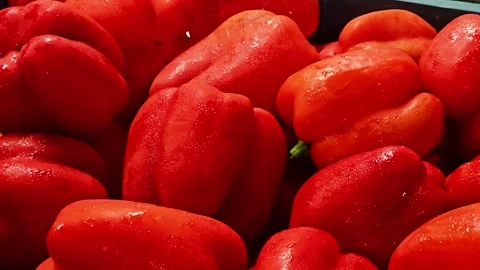 Close-up of fresh red bell peppers displaying bright skin, crisp texture Stock-Footage 347181773