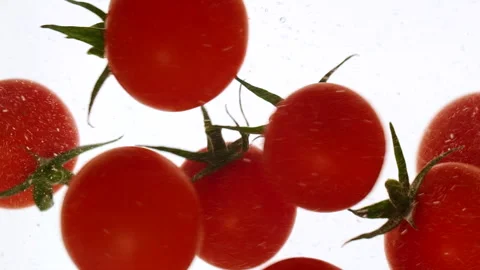 Close-up fresh red cherry tomatoes moving and splashing in water in slow motion Stock Footage 315017365
