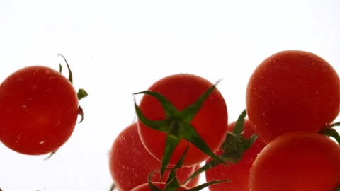 Close-up fresh red cherry tomatoes moving and splashing in water in slow motion Stock Footage 317069084