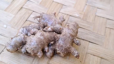 Close Up of Fresh Red Ginger Roots on Woven Bamboo Mat Stock Footage 340619003