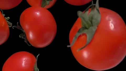 Close-up of the fresh red tomatoes falling diagonally on the black background Stock Footage 282647125
