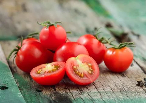 Close-up of fresh, ripe cherry tomatoes on wood Stock Photos
